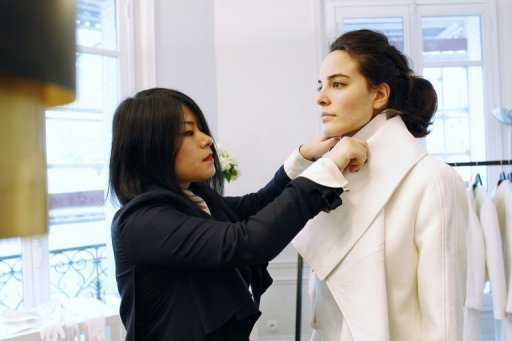 Chinea in parisdesigner-Masha-Ma-works-on-one-of-her-creations-worn-by-a-model-in-Paris